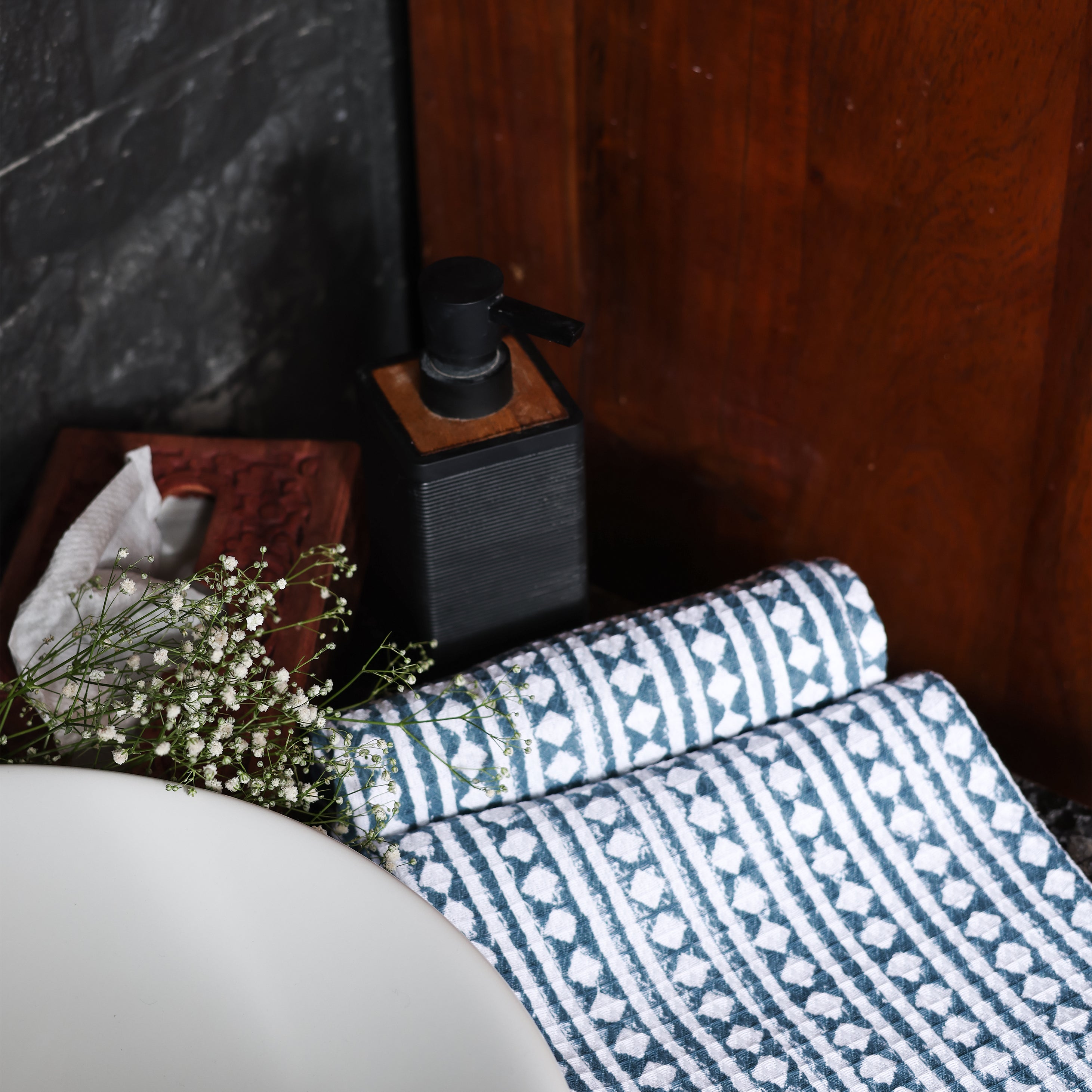 Cotton hand towel with blue and white geometric pattern on a surface.