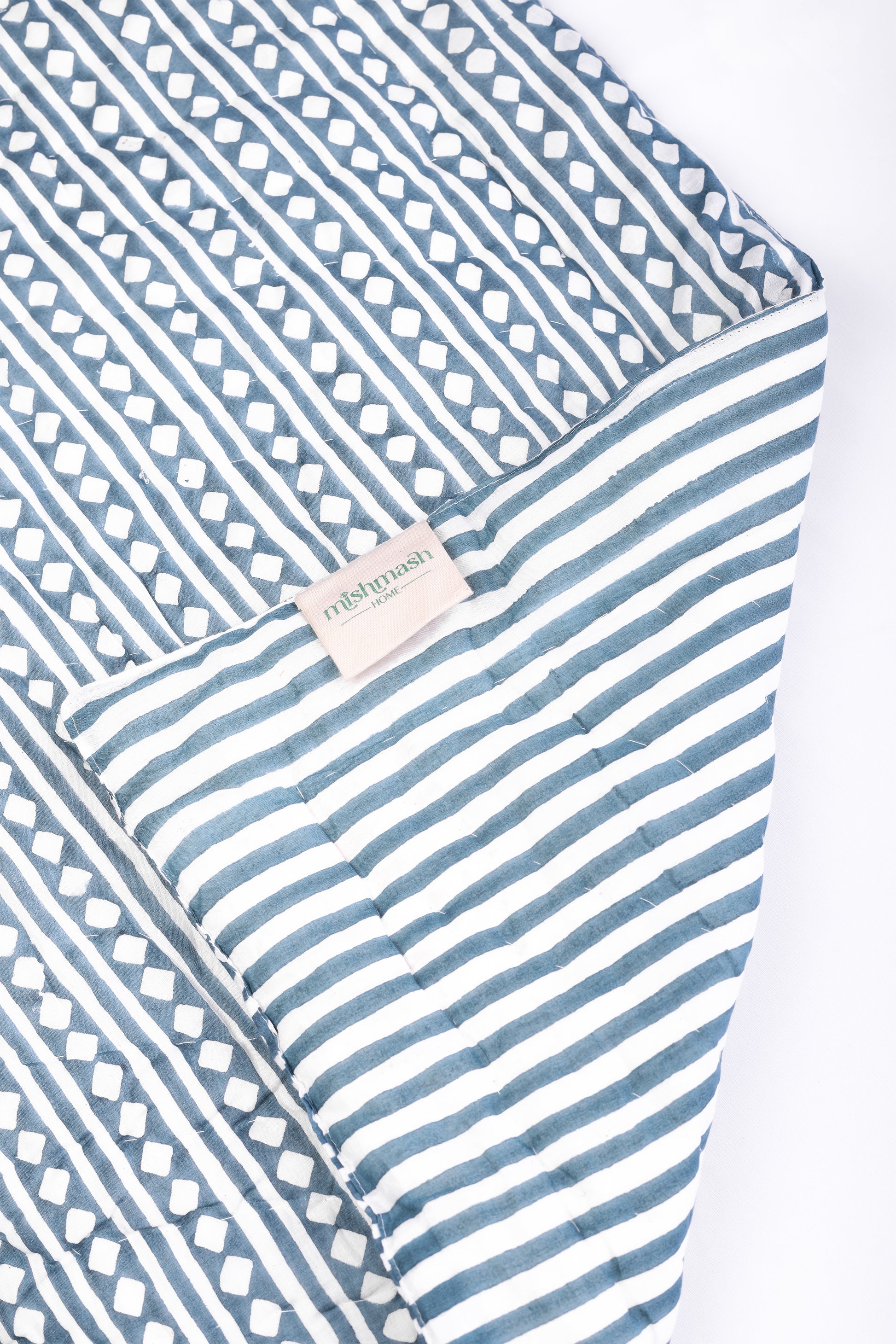 jaipuri razai with blue and white stripes on a white background. buy winter quilts.