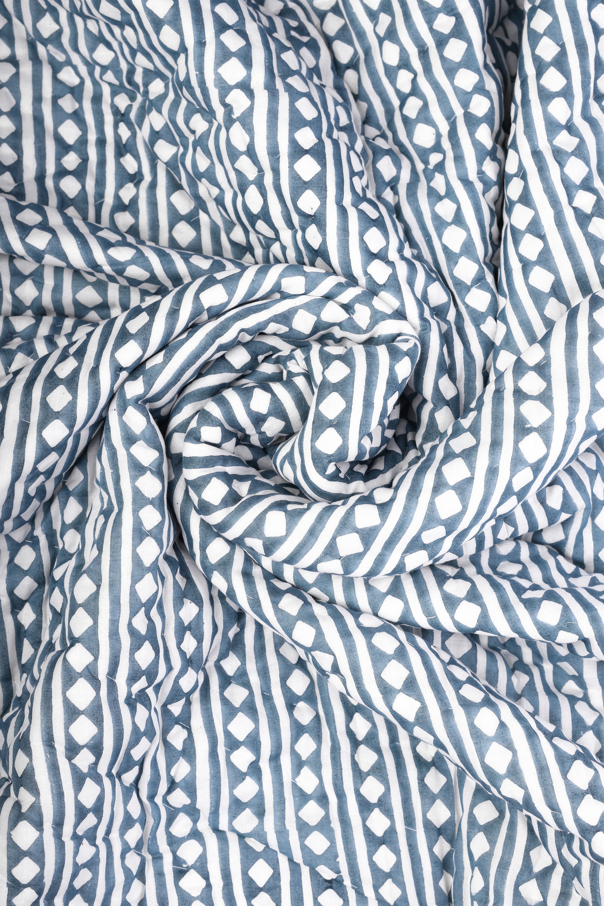 Close-up of blue and white printed ac quilt