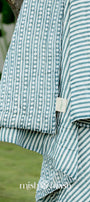 Close-up of a blue and white striped reversible jaipuri quilt