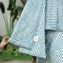 Striped jaipuri quits with a visible brand logo against a natural background. jaipuri razai.