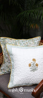 Two yellow cushion cover 16x16 on a chair with a plant in the background