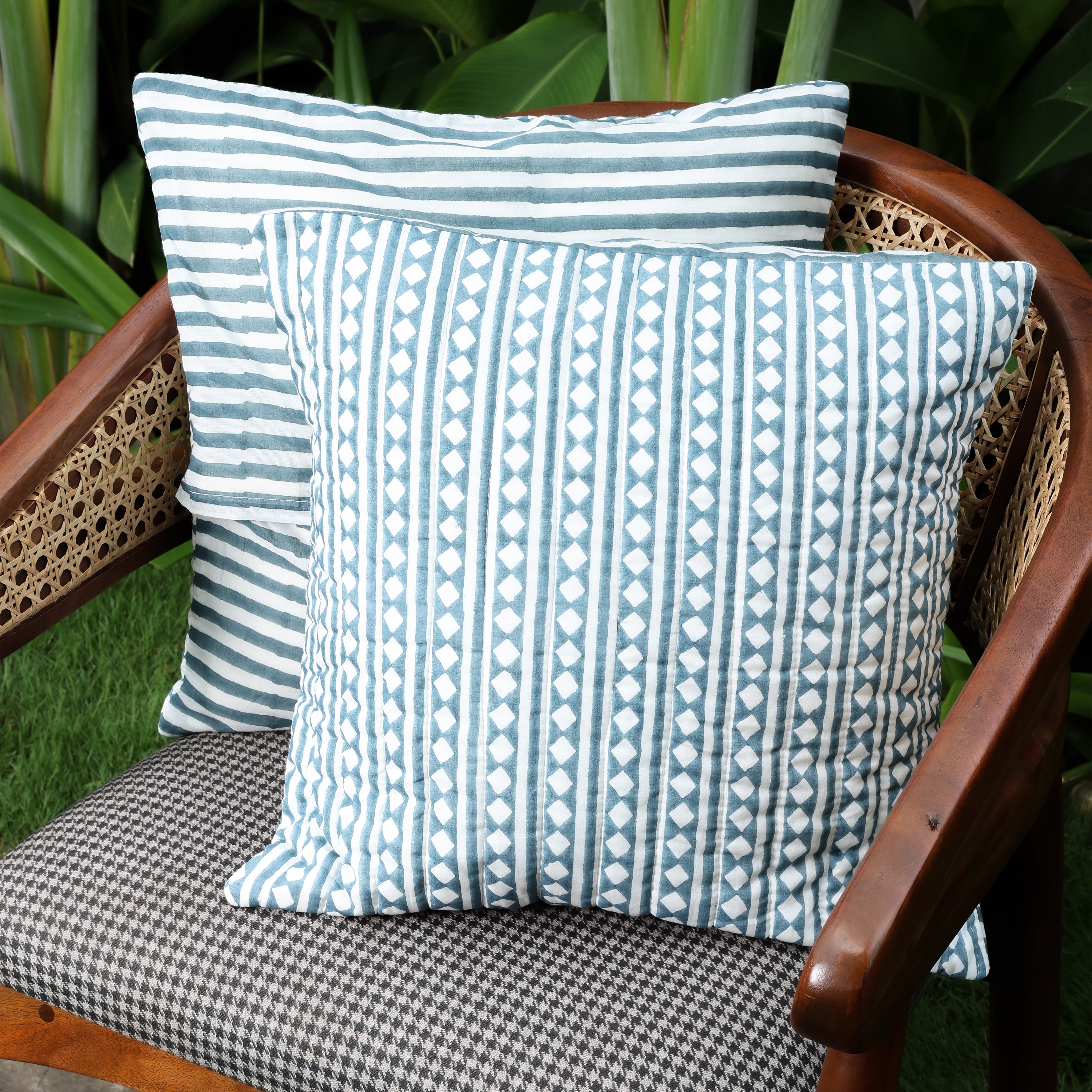 2 blue cushion covers kept on a chair