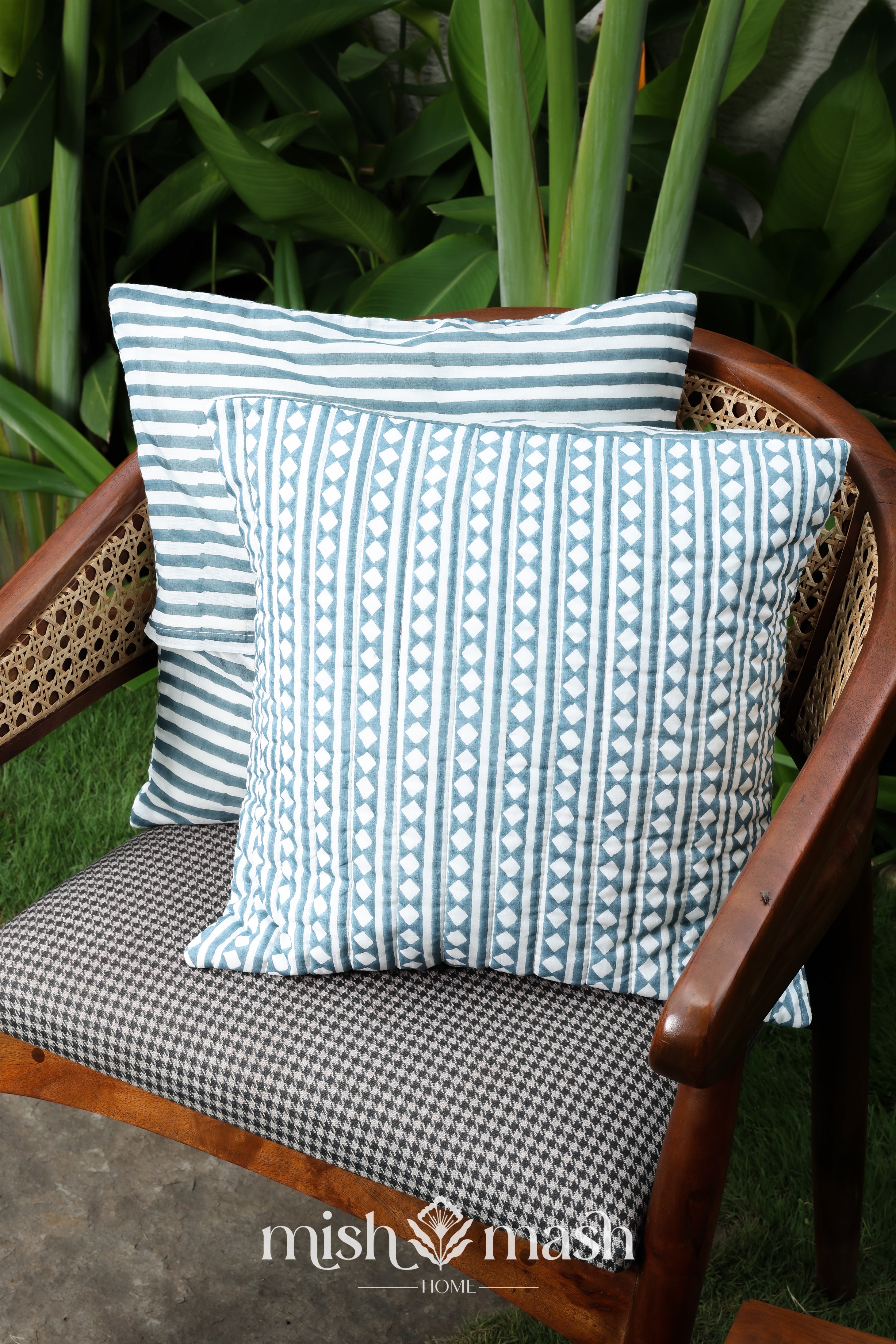 2 blue cushion covers kept on a chair
