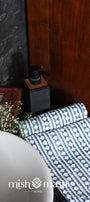 Cotton hand towel with blue and white geometric pattern on a surface.