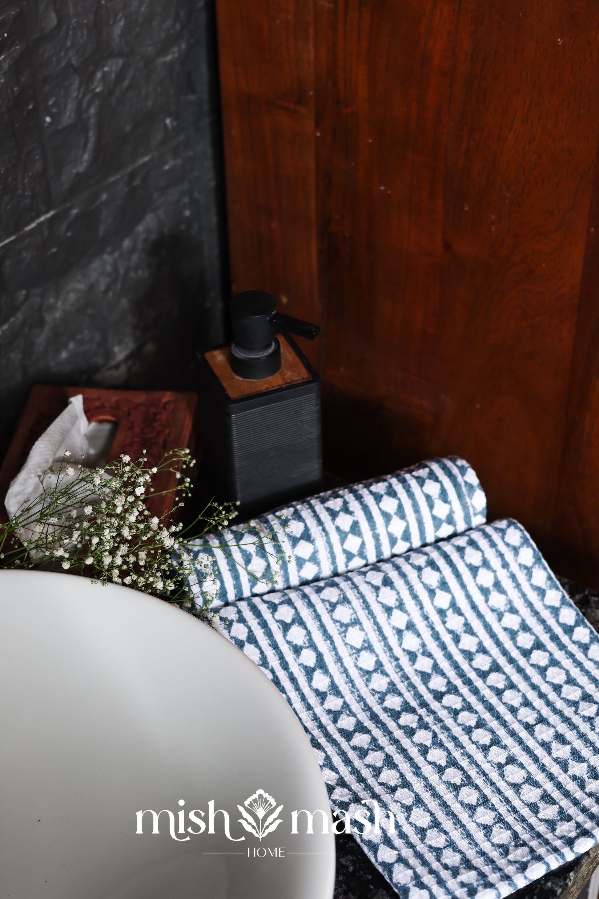 Cotton hand towel with blue and white geometric pattern on a surface.