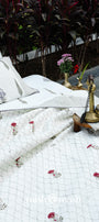 White cotton bedspread with floral patterns on top of a double bed sheet in cotton. Buy luxury bedspread online.
