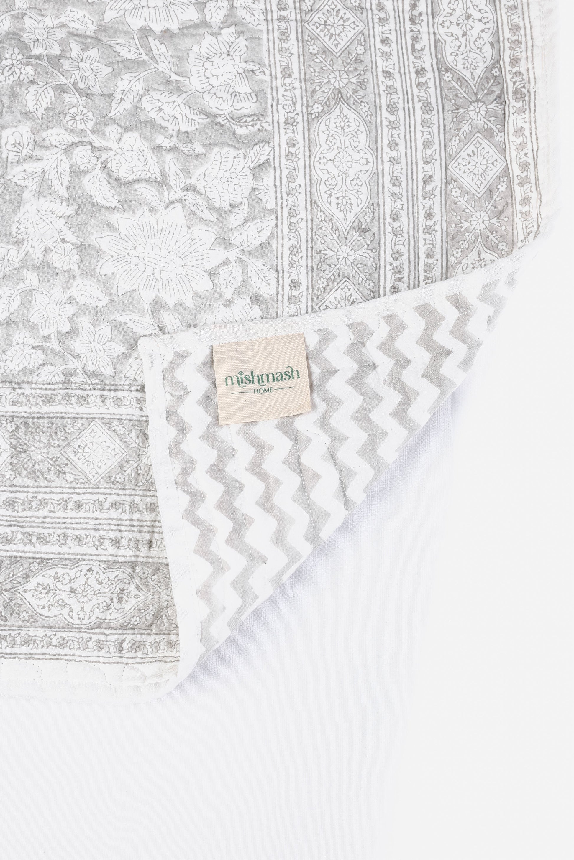Grey reversible bed spread online with floral print on one side and grey chevron print on reversible side