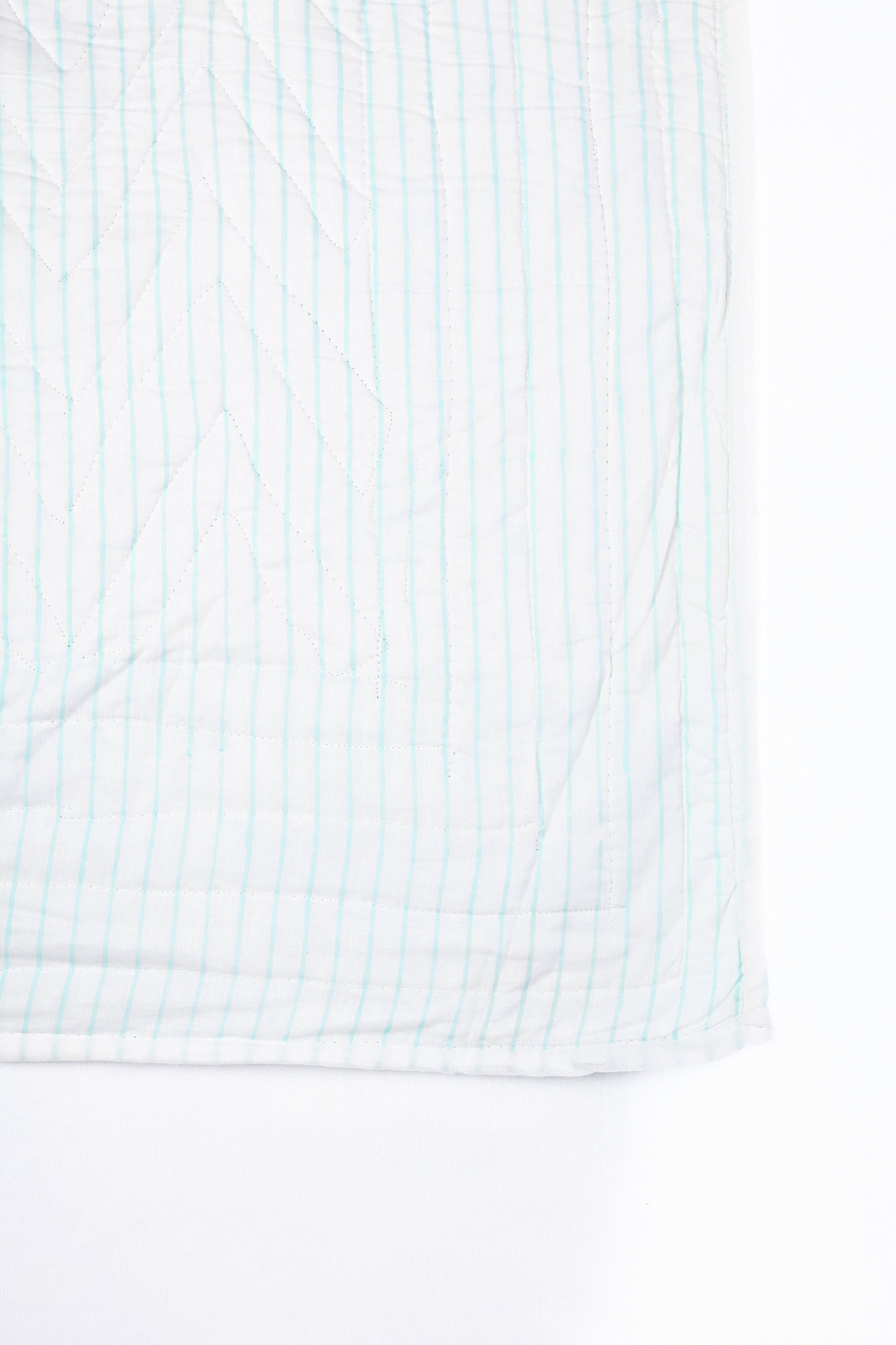 Reversible cotton bed spread with aqua blue and white stripes on one side