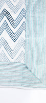 Reversible quilted cotton bed spread with blue and white zigzag pattern on a white base