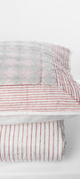 red and white vertical striped cotton bed spread with matching geometric cotton pillow cover 