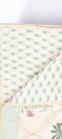 Reversible quilted cotton luxury bed spread with green and pink paisley motifs and palm motifs on back side