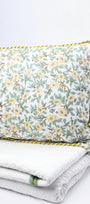 Floral pillow cover and cotton bed cover set on a white background