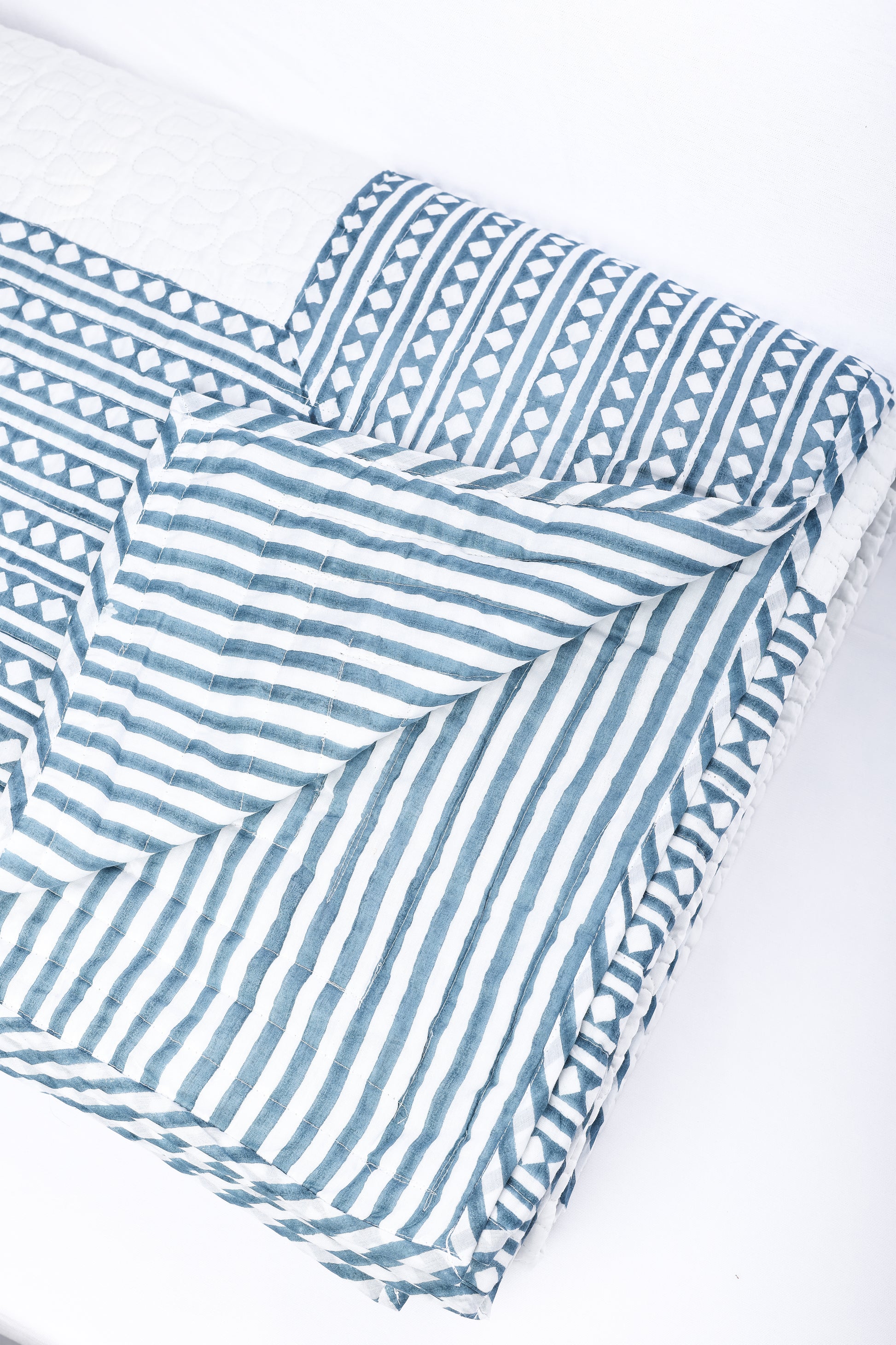Blue and white stripped cotton bed cover hand quilted. Buy luxury bedspread online.