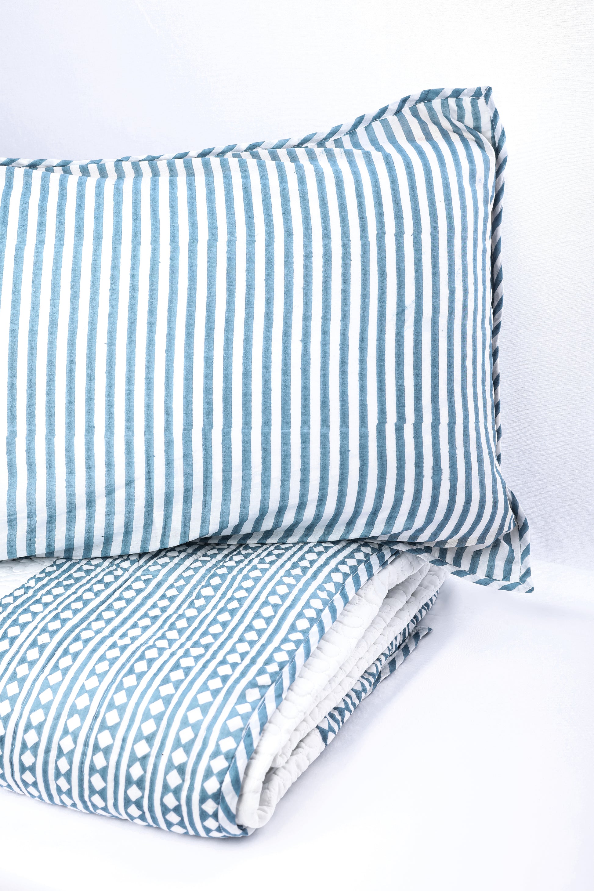 Blue pillow with cotton quilted bed cover. Buy luxury bedspread online.