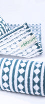 Folded hand napkins with blue and white print and 'mishmash' branding on a white background.