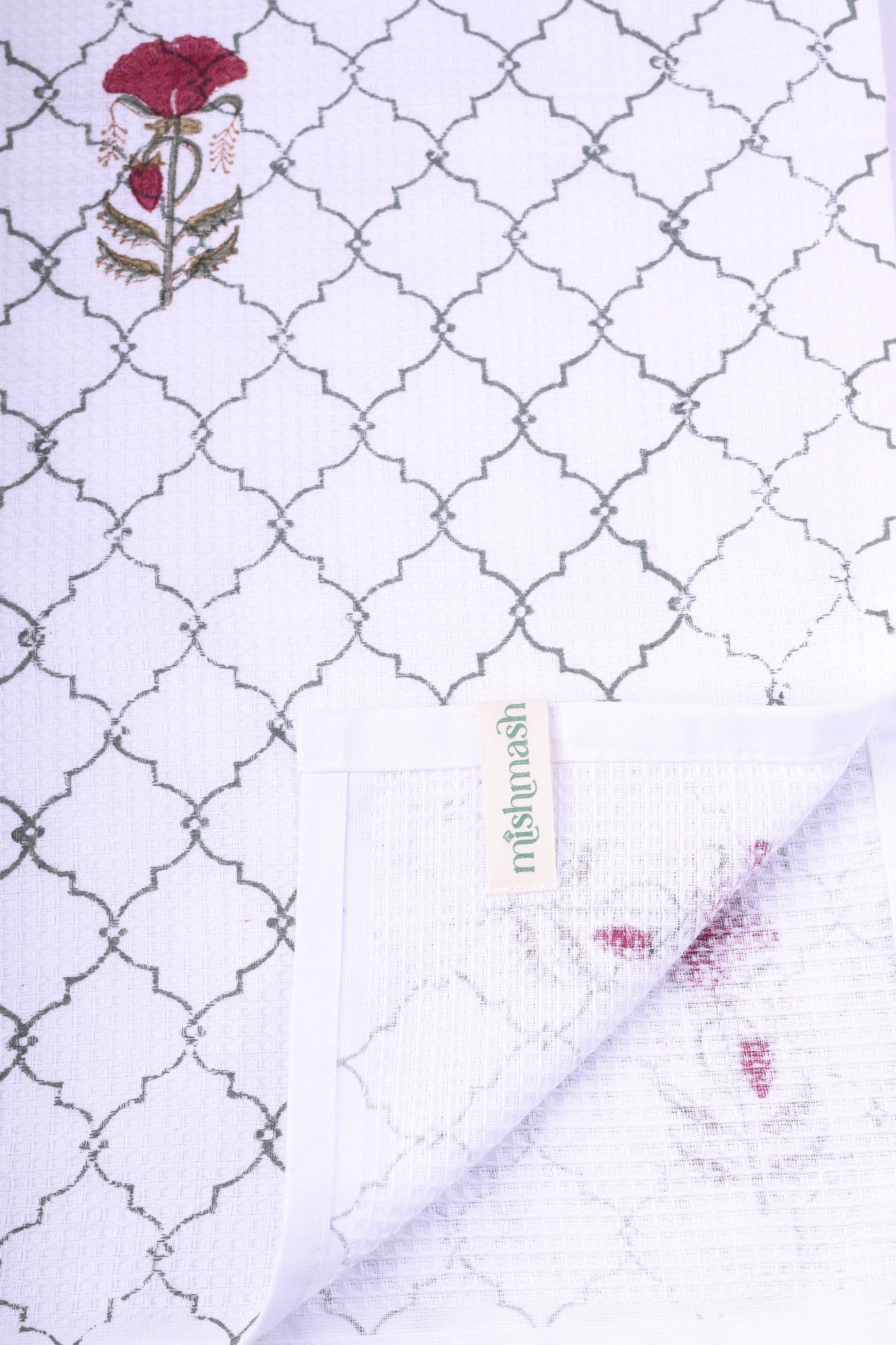 Bath linen with a floral pattern and brand name. Quick dry towel for women.