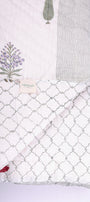 Reversible winter Quilt with block print floral illustration on a white background. Buy all seasons jaipur razai.