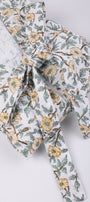 Floral-patterned bathrobes for women with a tie on a light gray background