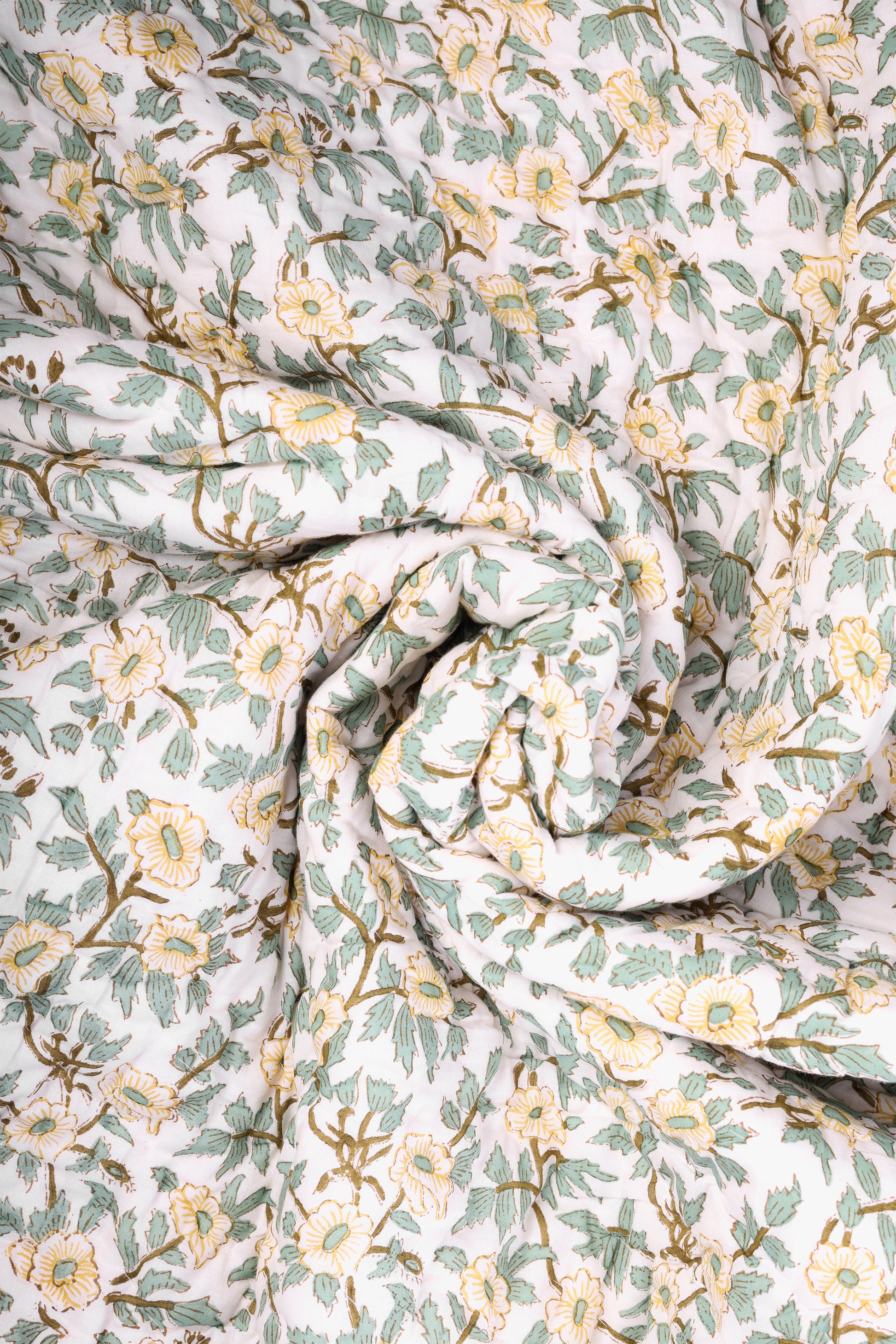 Roll of floral jaipuri razai with green and yellow flowers. Buy winter quilts.