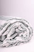 Folded double bed comforter with ash green stripes on white base. Buy winter comforter online.