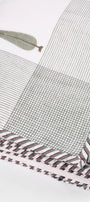 Close-up of cotton dohar blanket with striped, checkered, and patterned designs. 