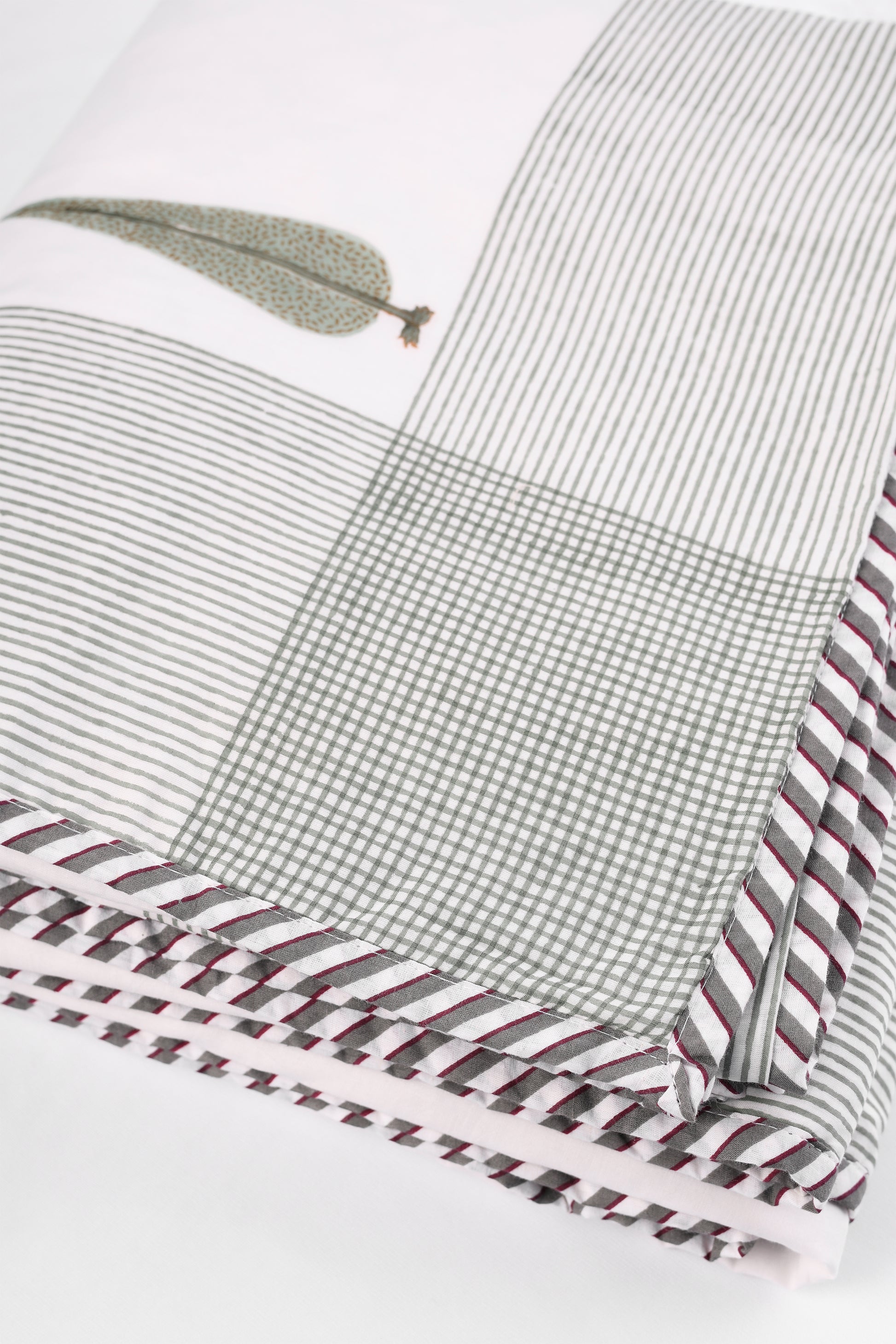 Close-up of cotton dohar blanket with striped, checkered, and patterned designs. 