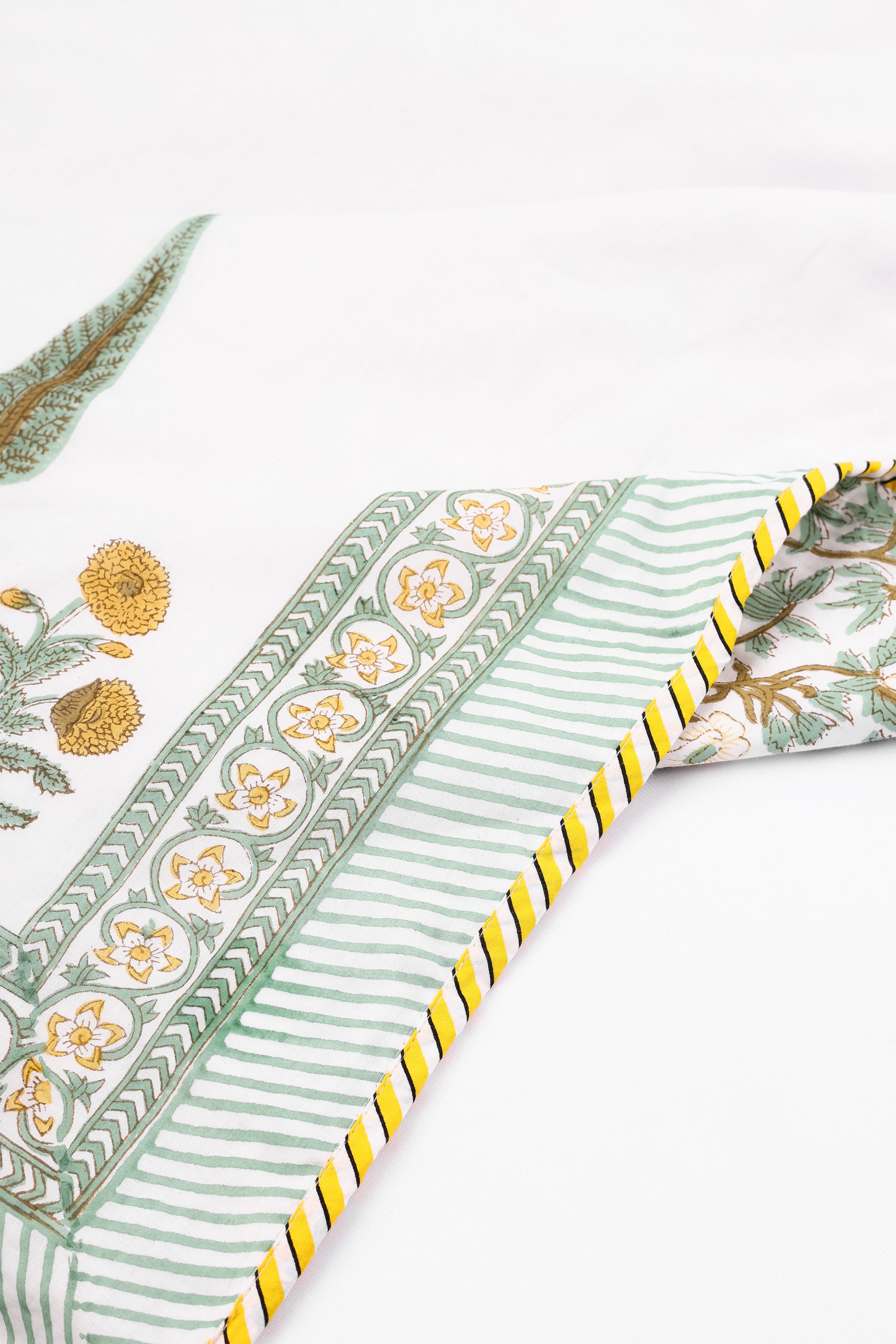 Cotton dohar blanket with yellow floral and striped hand block print on a white background. Buy dohar online. ideal for summers.