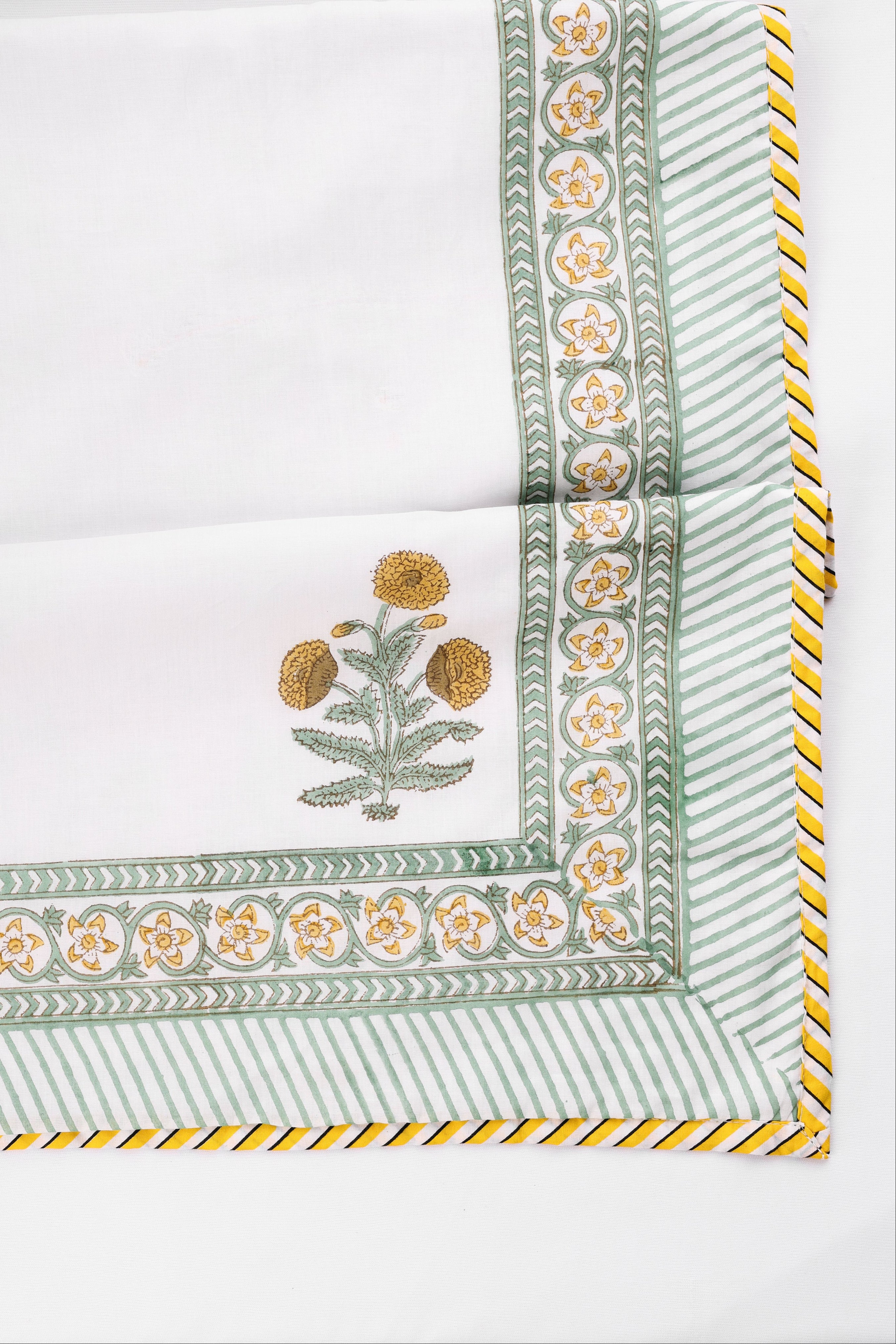 Decorative cotton dohar blanket with floral print and yellow trim on a white background. single bed dohar and double bed dohar.