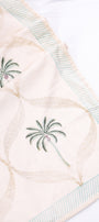 Light yellow AC Dohar blanket with palm tree designs on a white background