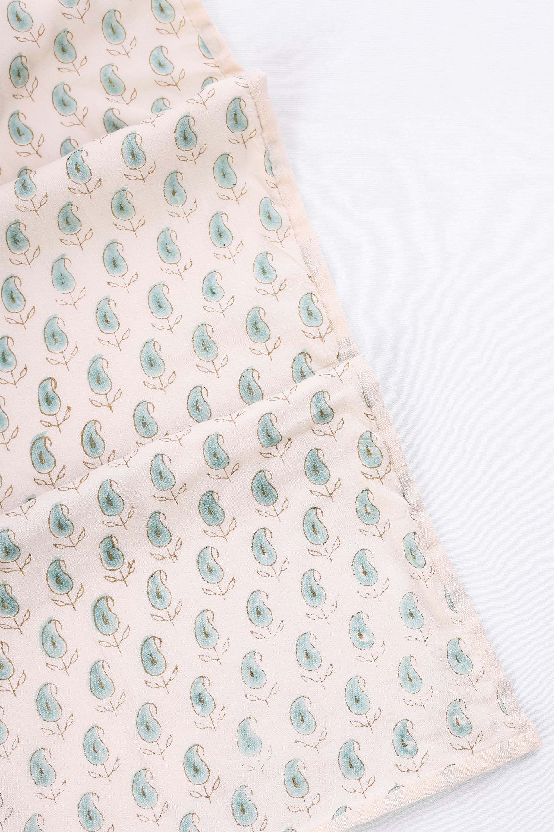Summer blanket with a pattern of green PAISLEY MOTIFS on a A LIGHT YELLOW DOHAR