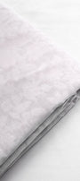 Folded white cotton dohar used in summers