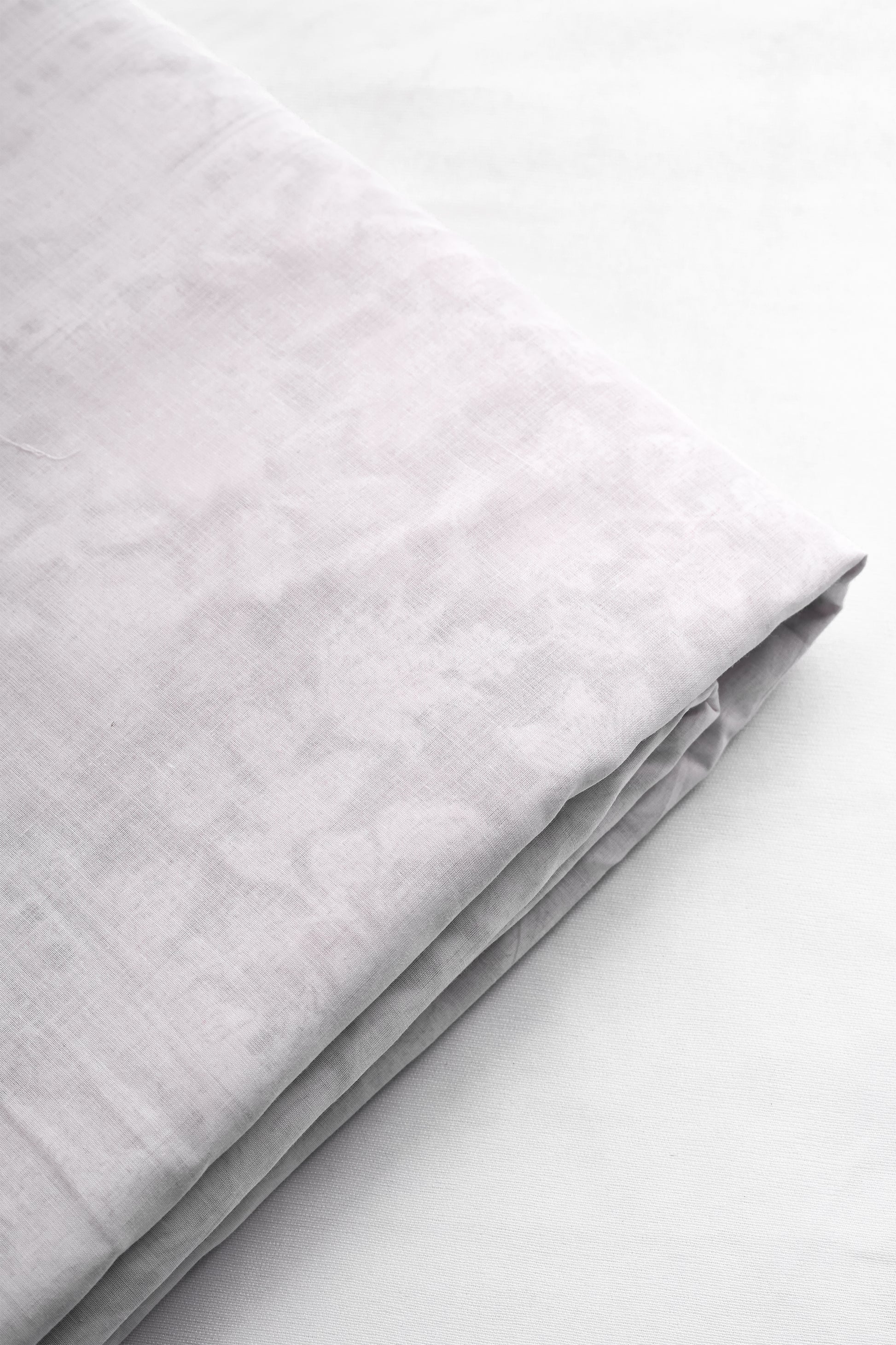 Folded white cotton dohar used in summers