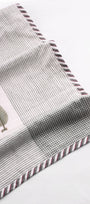 Close-up of a cotton dohar blanket with striped and checkered print on a white background. Buy summer blanket.