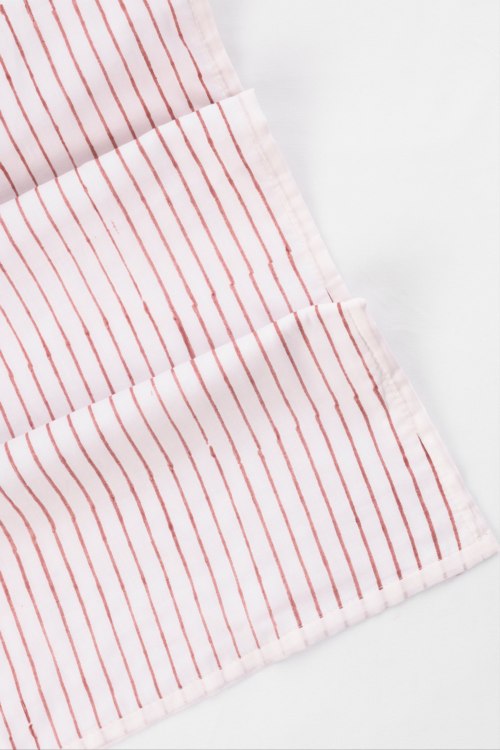 Red stripes on a white dohar blanket