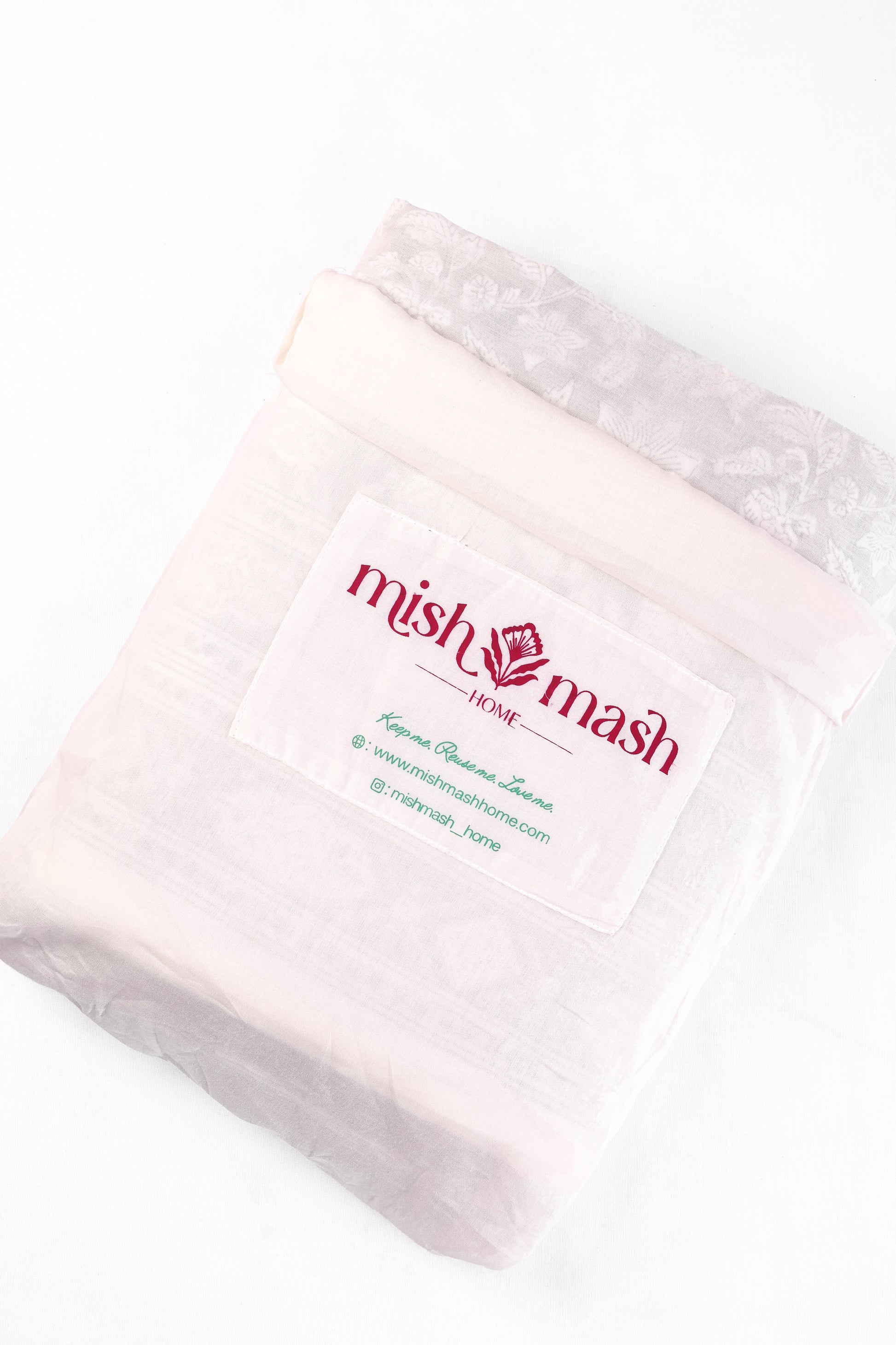 white and grey cotton dohar blanket in a White bag with 'mish mash' branding 