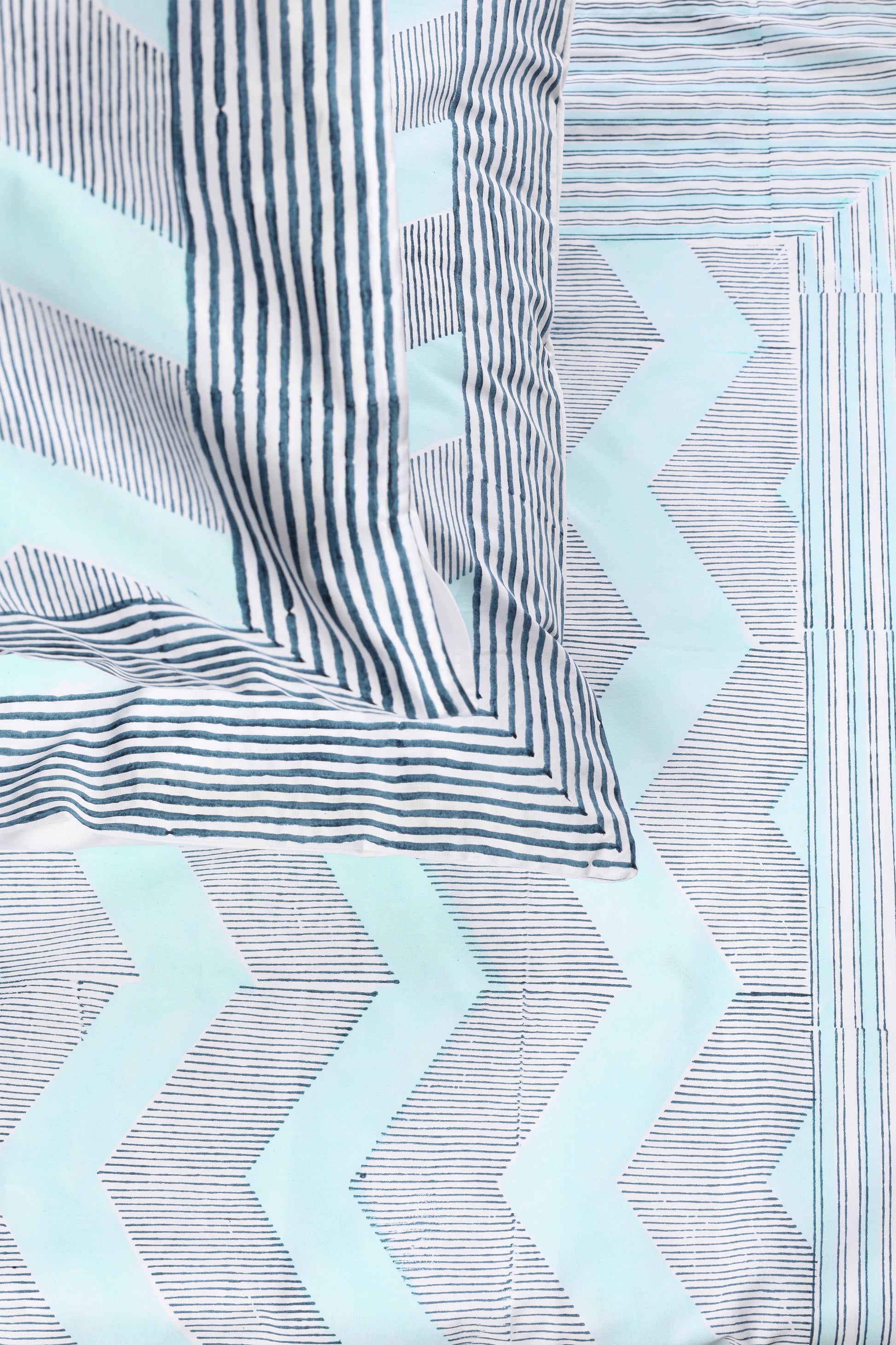 Cotton bed sheet with blue and white geometric design and two matching cotton pillow covers 