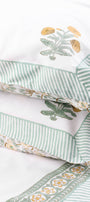 Close-up of a pillow with jaipur bedsheets on a white background, made in pure cotton. ideal home decor gifts for wedding