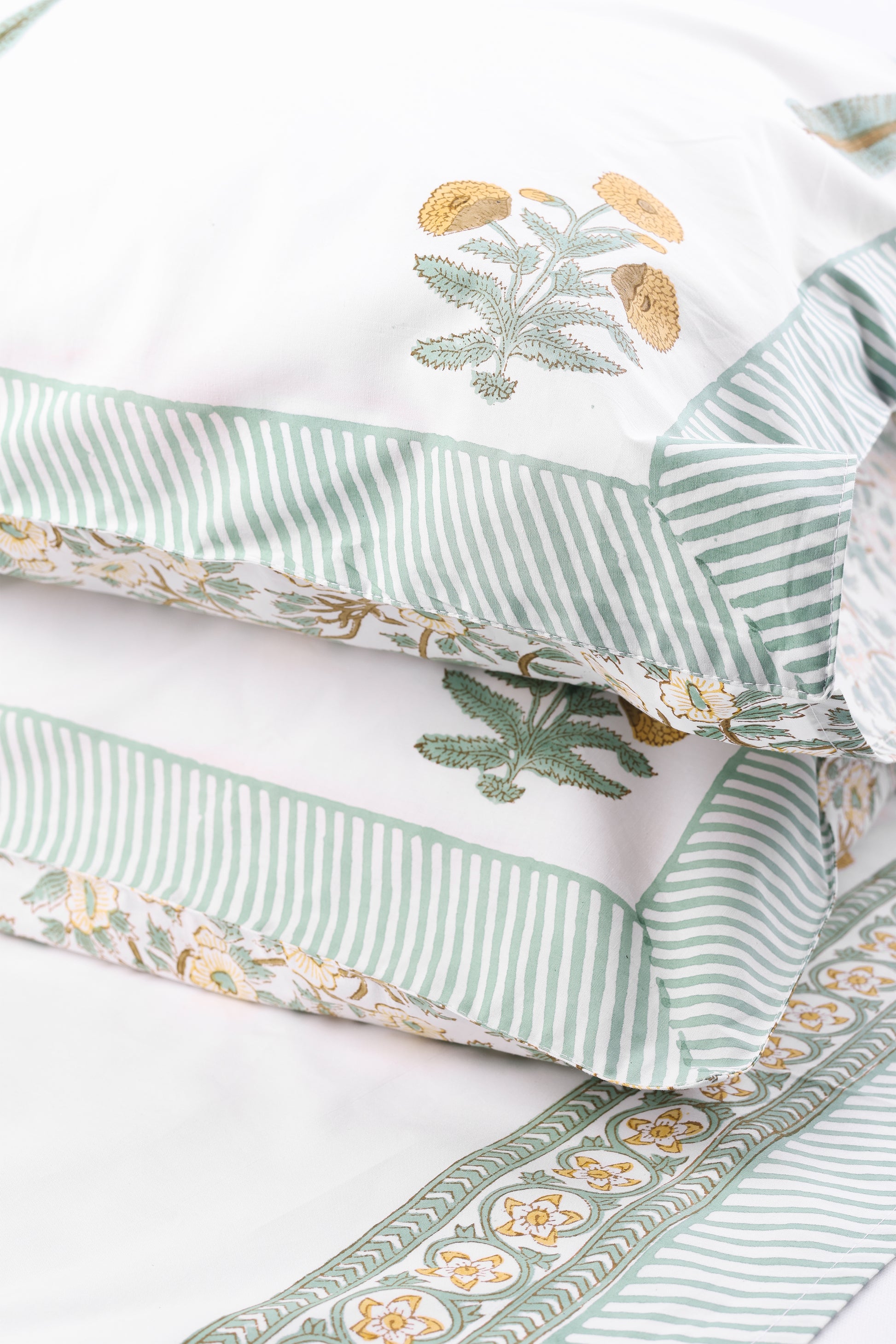 Close-up of a pillow with jaipur bedsheets on a white background, made in pure cotton. ideal home decor gifts for wedding