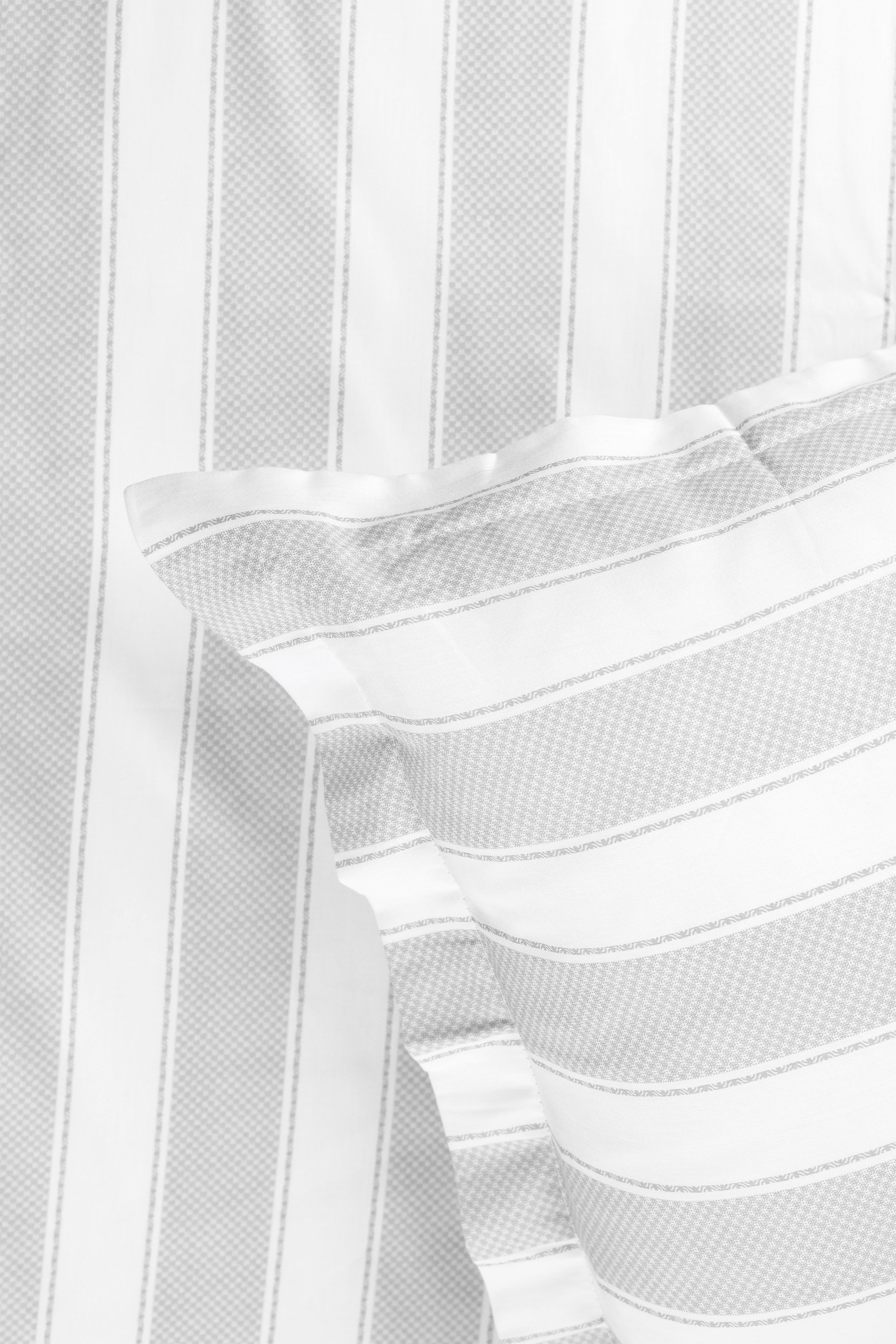 Close-up of a white and grey 400 tc double bed sheet with matching pillow cover. spaces bedsheet.