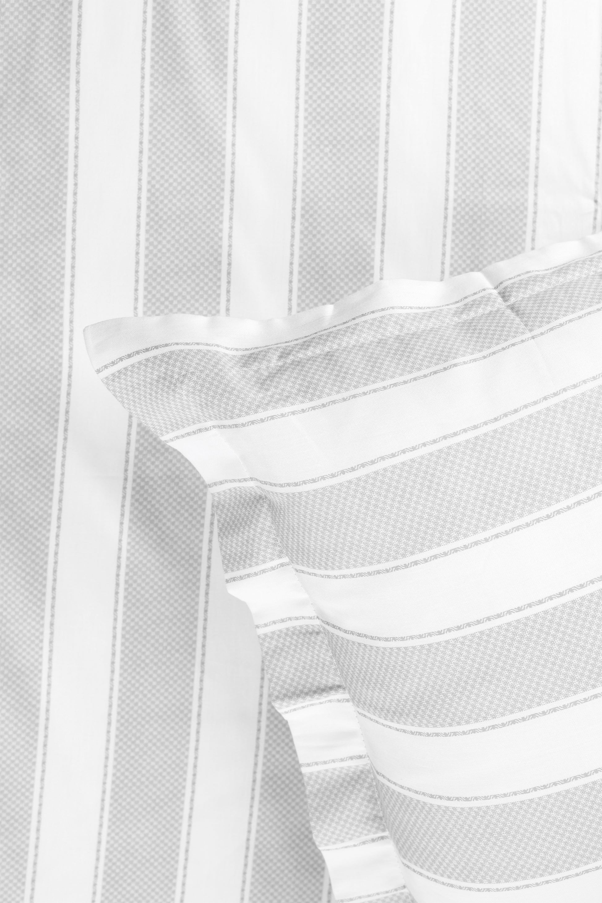 Close-up of a white and grey 400 tc double bed sheet with matching pillow cover. spaces bedsheet.