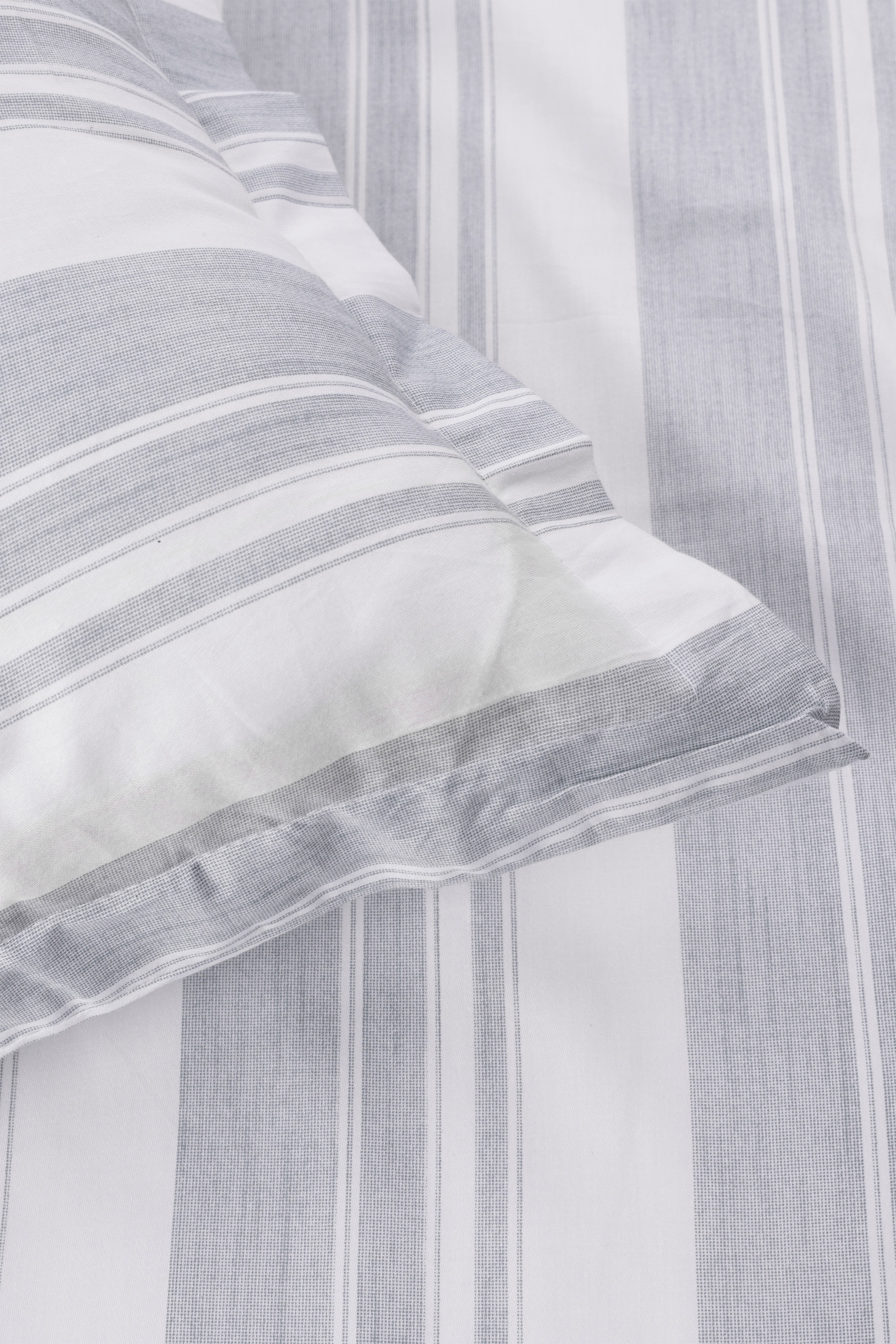 Close-up of a ash green and white striped geomtric pure cotton double bed sheet