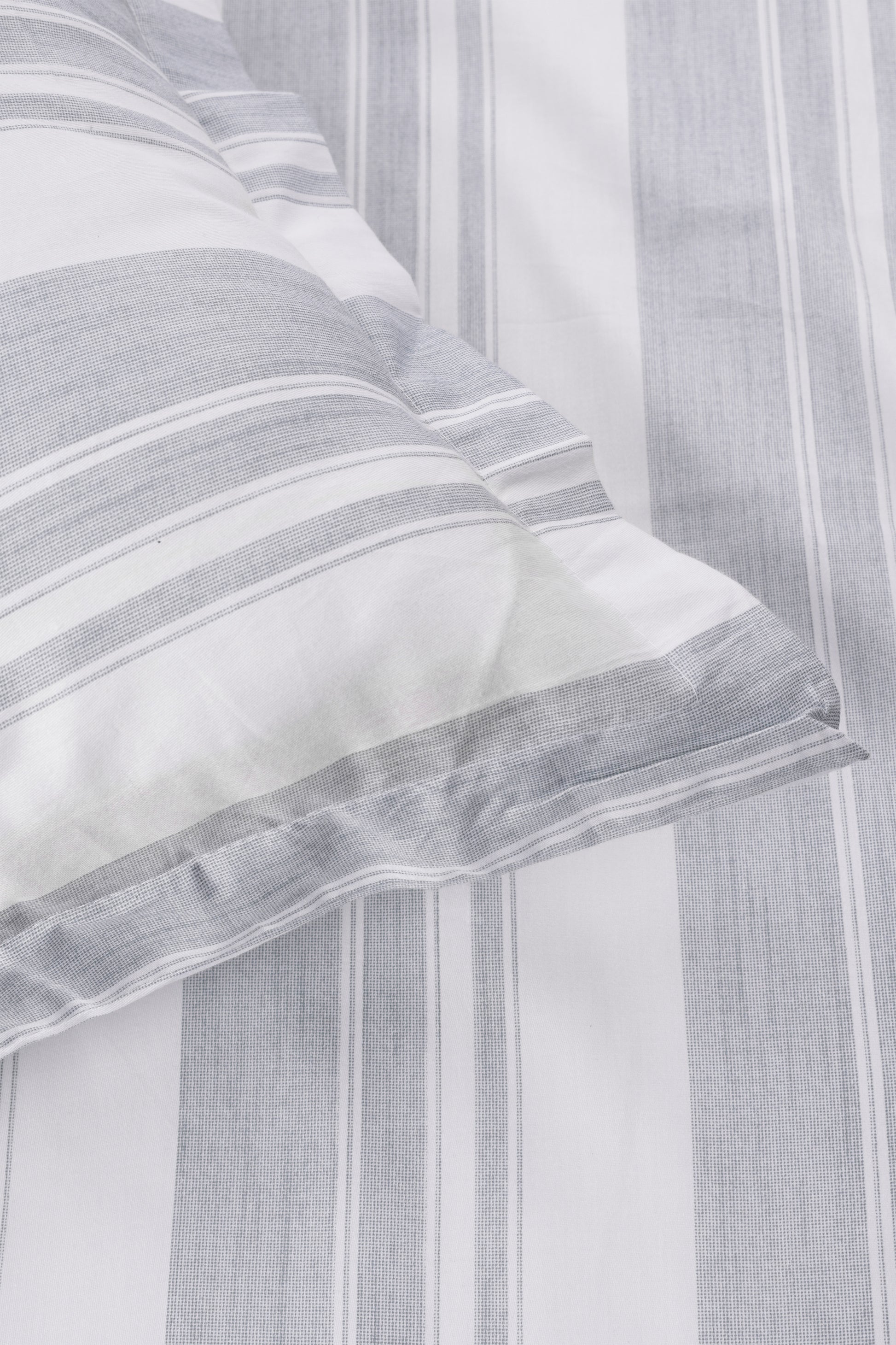 Close-up of a ash green and white striped geomtric pure cotton double bed sheet