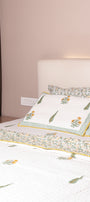 Bed with floral bed cover that is reversible. buy luxury bedspreads online.