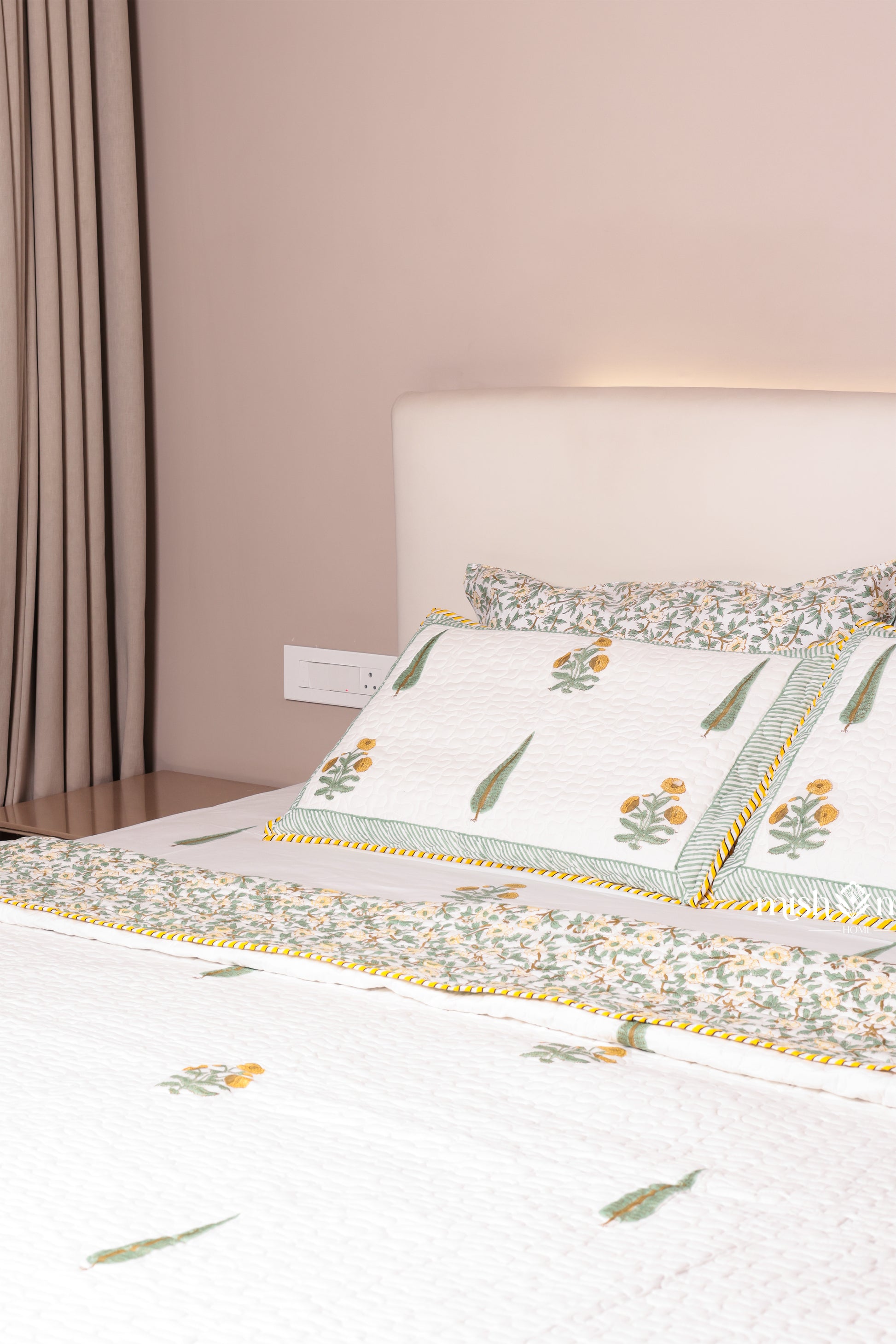 Bed with floral bed cover that is reversible. buy luxury bedspreads online.