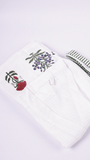 A folded white waffle cotton bathrobe featuring hand block printed floral motifs