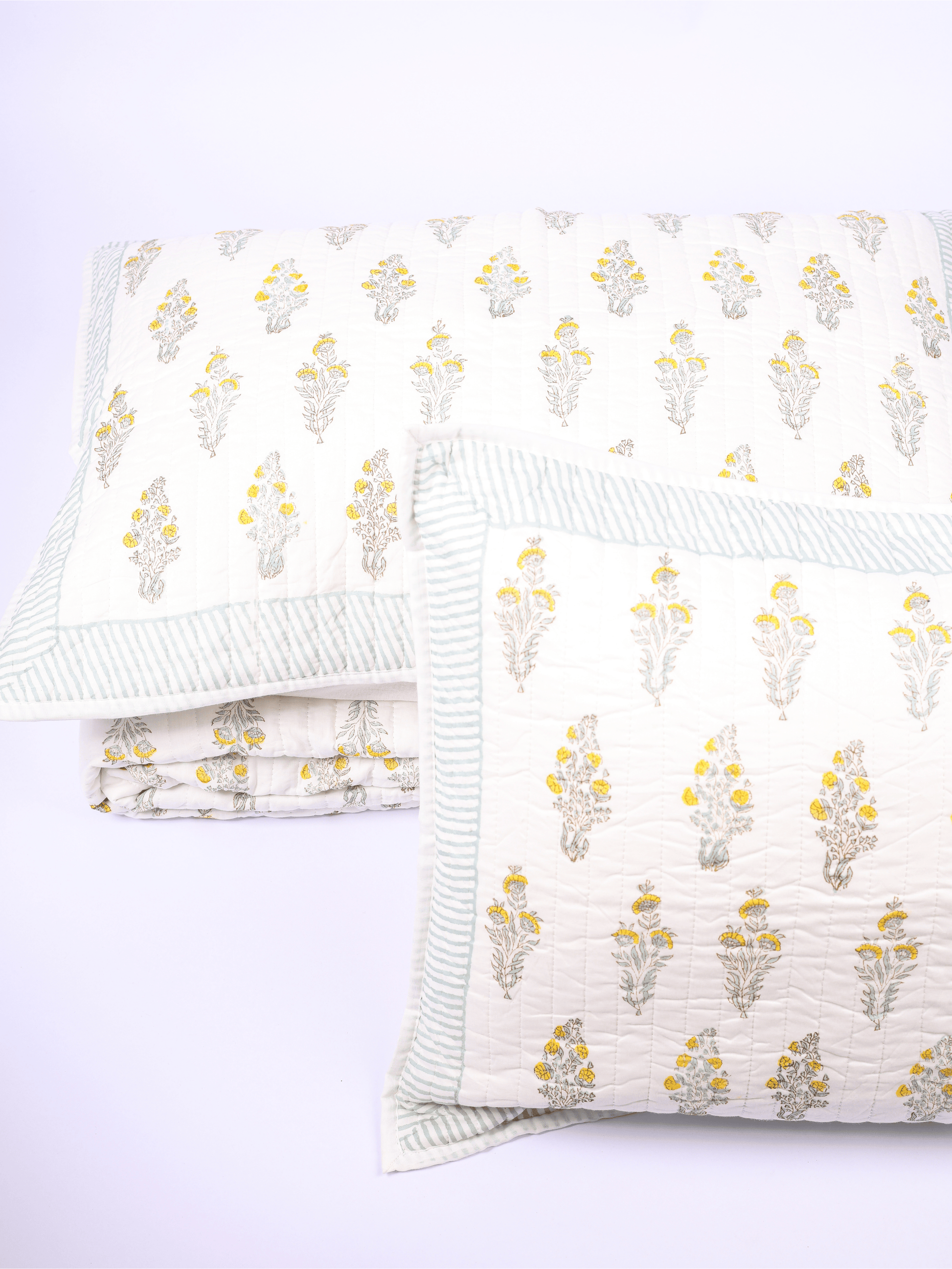 Double bed cover with matching pillow covers in green and yellow