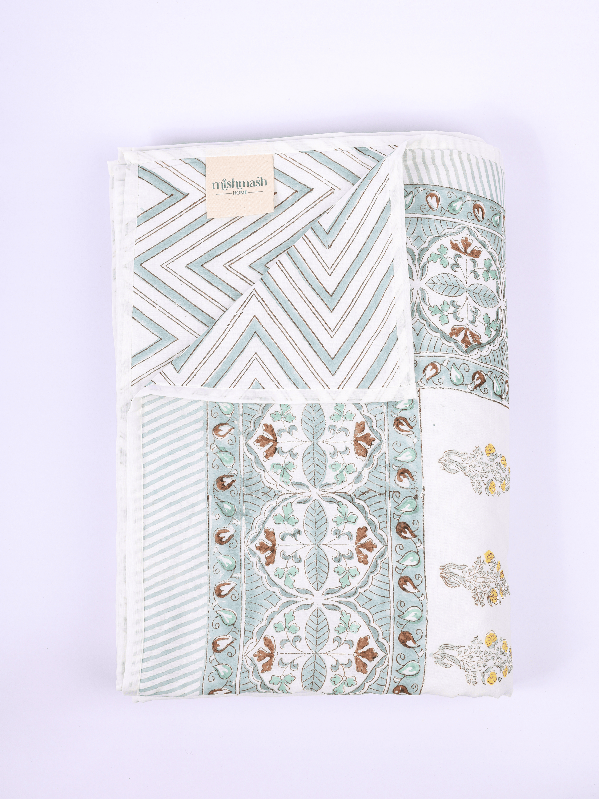 Double bed dohar with green chevrons and floral reverse