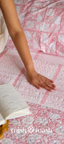 Quilted double bed cover with peach floral and striped design
