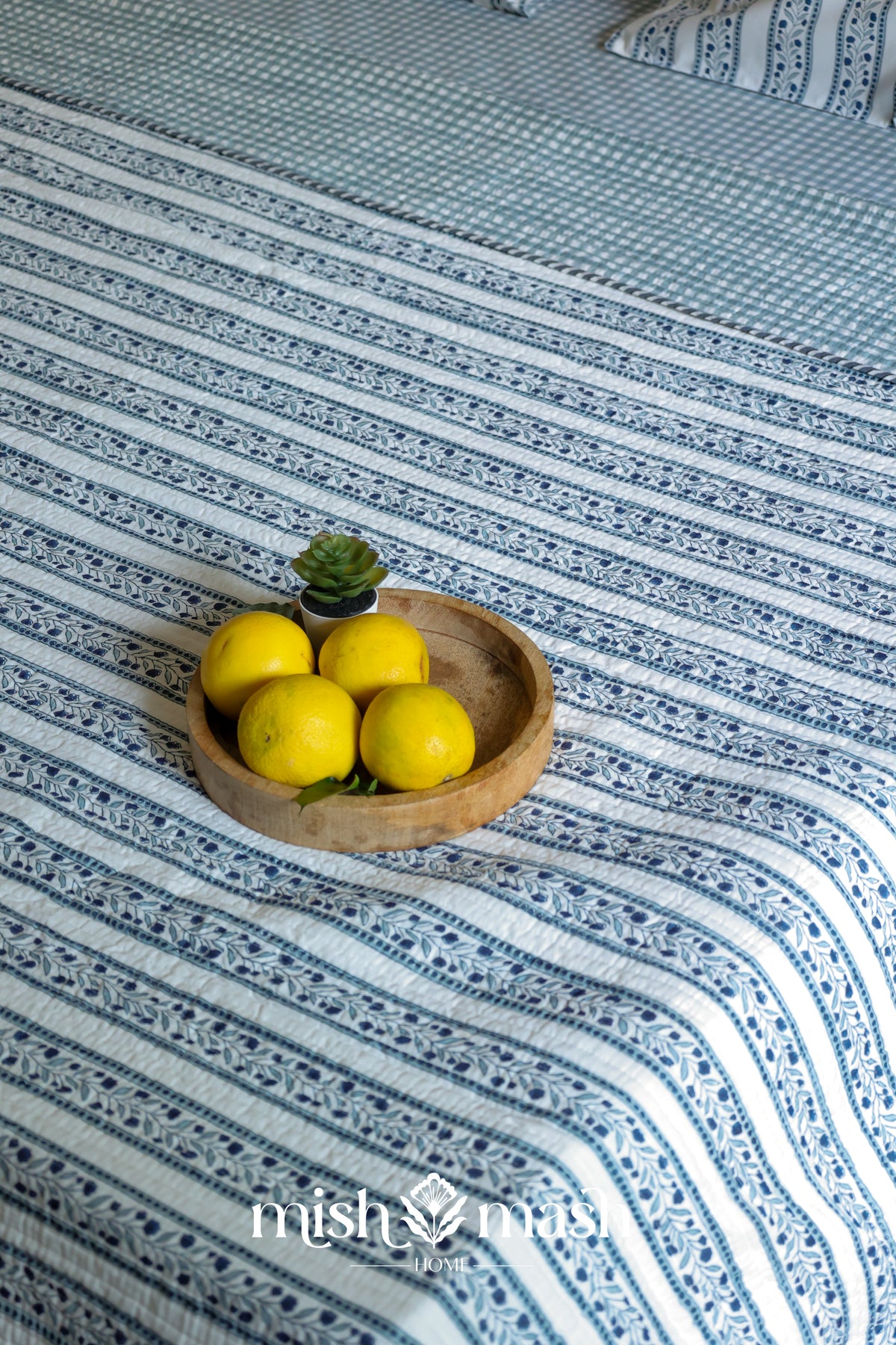 blue double bed cover with floral print